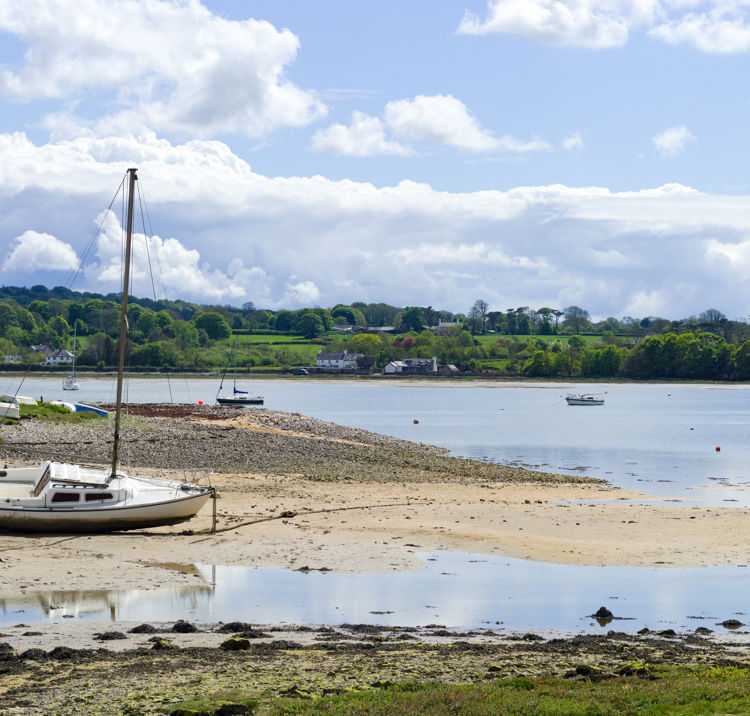 Red wharf bay, Anglesey, Wales. Beautiful landscape of sea and sand at low tide. Small pleasure boats on the sand flats. 